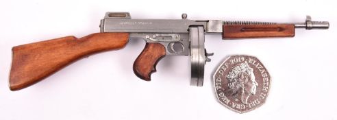 A well detailed miniature model of a Thompson sub-machine gun, 5¾" overall, with drum magazine.