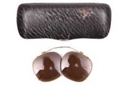 A pair of WWII dark glass clip on covers for glasses, reputed to be Afrikakorps, with adjustable