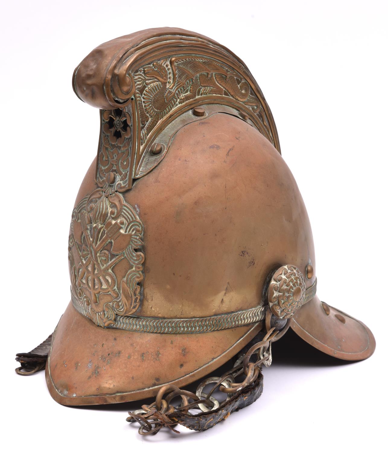 A fireman's brass helmet, c 1900, of universal pattern with dragon crest, crossed axes plate,