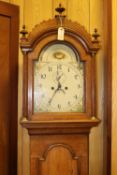 An oak cased longcase clock. Early 19th Century clock striking on a bell with an 8 day movement,