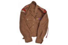 A 1949 pattern khaki battledress blouse, with black on red R.A.O.C. embroidered cloth titles,