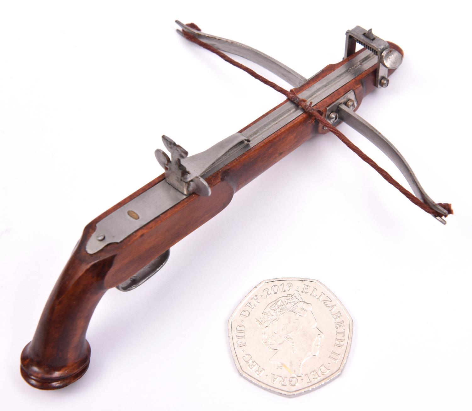 A miniature model of a pistol crossbow, length 4½", span 3½". GC £30-40