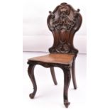 A 19th Century hall chair with a carved oak back. Togther with a 19th Century mahogany towel rail
