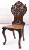 A 19th Century hall chair with a carved oak back. Togther with a 19th Century mahogany towel rail