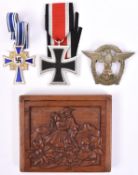 A Third Reich Iron Cross 2nd Class, a Deutsche Mutters Kreuz; an England Awake badge and a small