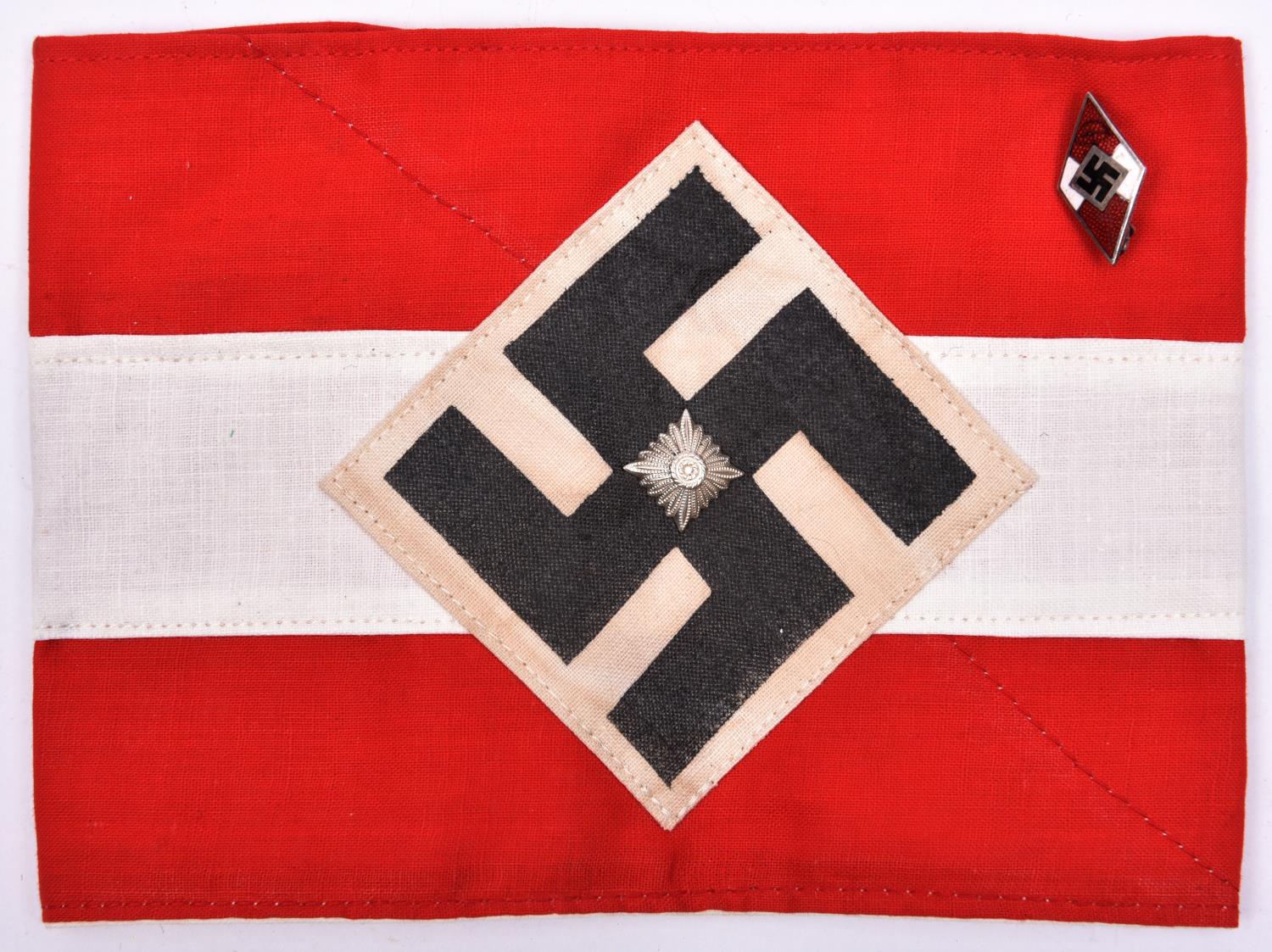 A Third Reich Hitler Youth armband, with applied diamond swastika patch and centrally mounted "Pip";