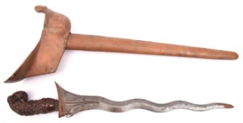 A Malay Kris, wavy watered blade 14½", the wooden hilt deeply carved with flowers and foliage and