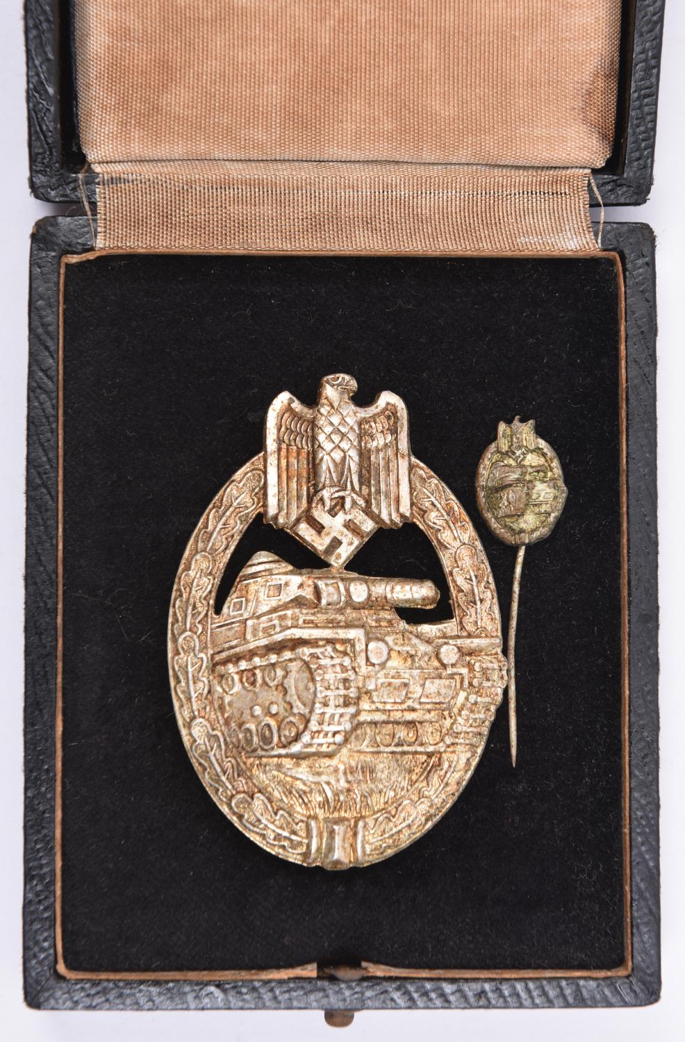 A Third Reich Panzer Assault badge, stamped construction silver washed complete with tiepin. In