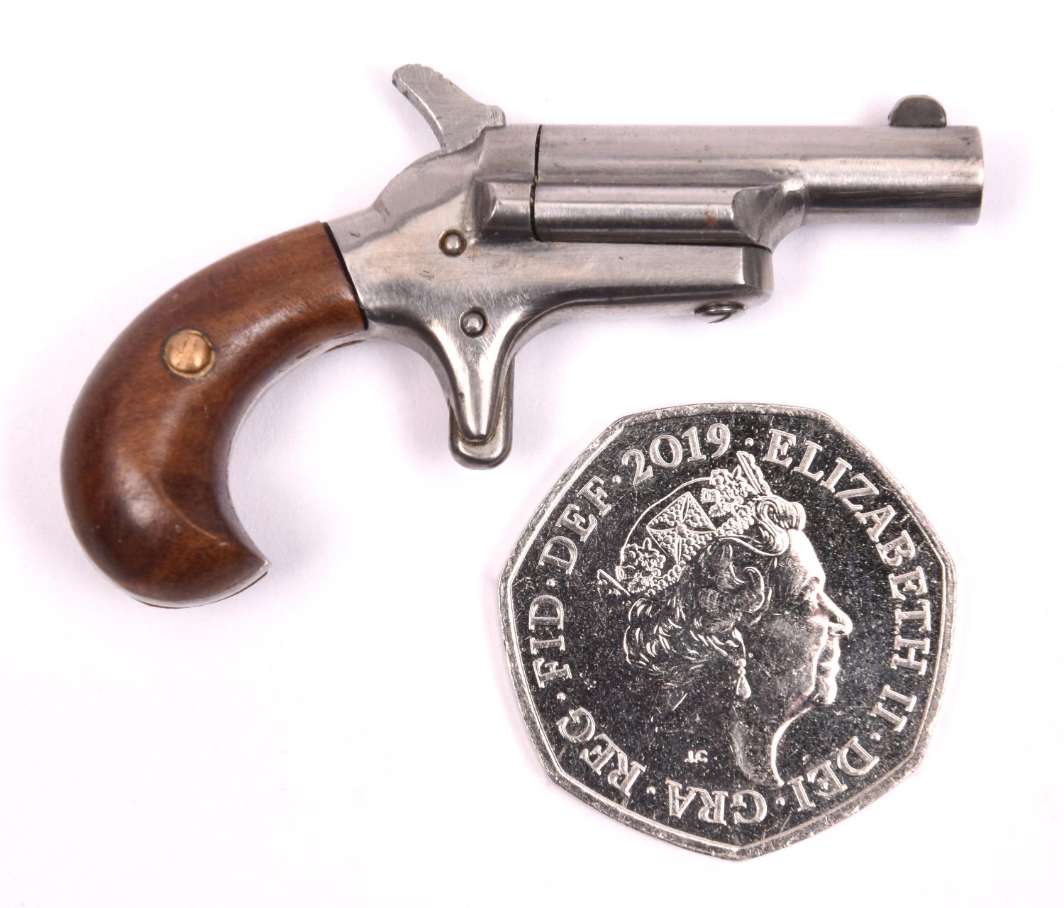 A miniature model of a Colt No 3 derringer pistol, 2¼" overall. GC £30-50