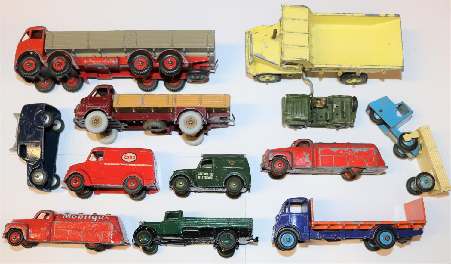 12 Dinky Toys. Including; Foden wagon. 2x Studebaker petrol tankers. Trojan van, Esso. Big