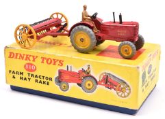 A Dinky Toys Farm Tractor & Hay Rake (310). A Massey-Harris tractor in red with yellow wheels and