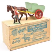 A Benbros Qualitoy Farm Hay Cart with farm labourer 'Log-Carrier. In yellow with light green body,