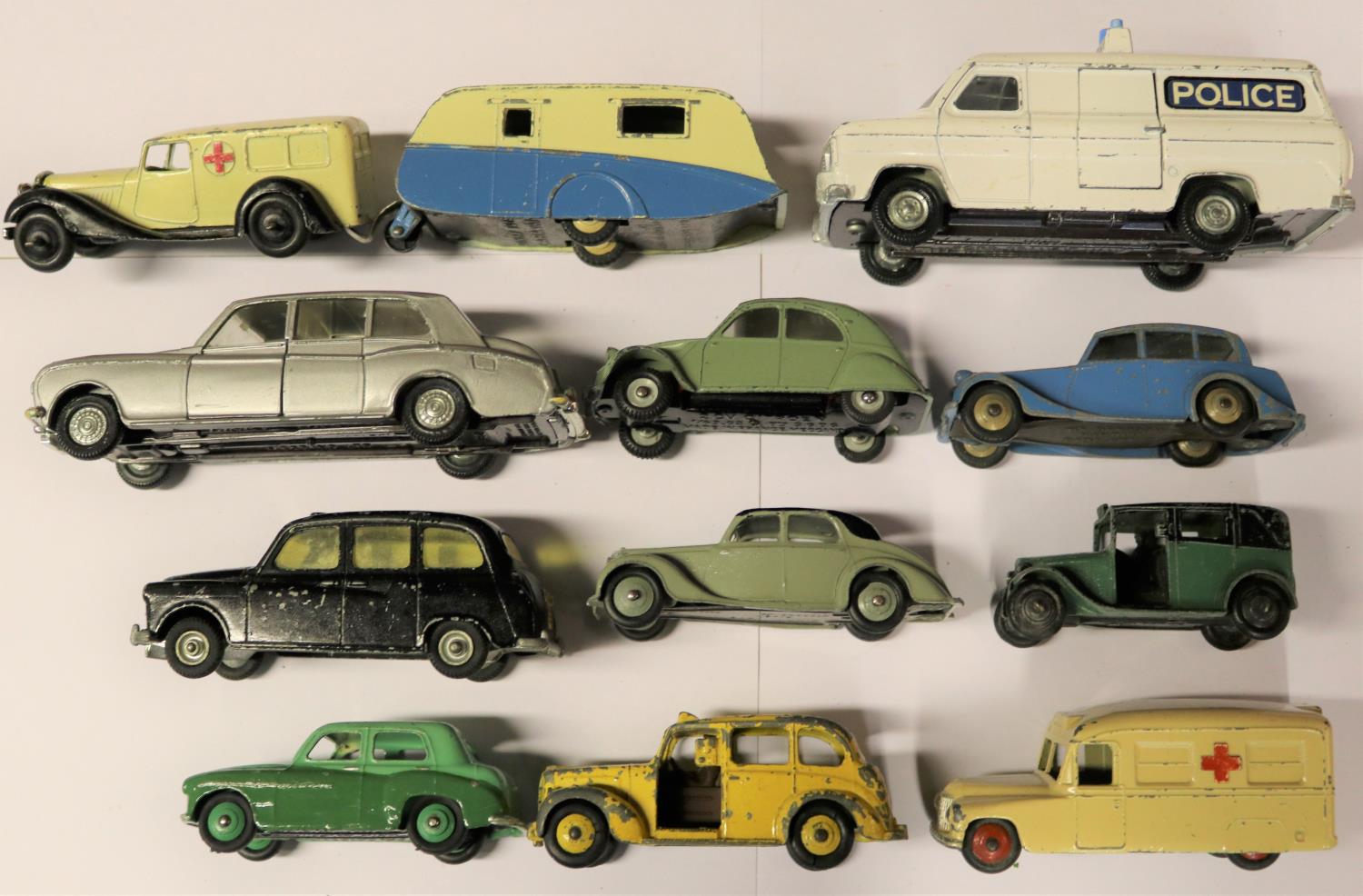 11 Dinky Toys and Budgie. Including; caravan. Citroen 2CV. 3x taxi, including Budgie. Ford Transit