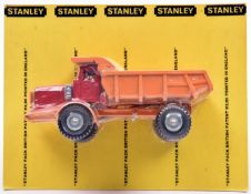 A rare Budgie Euclid Dumper. With red cab and orange chassis and tipping rear body. In 'Stanley'