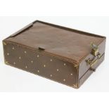 A tooled leather travel writing box with note pad and lower drawer, brass lock and handle, J.C.