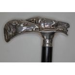 A modern silver handled walking stick, the handle formed from horses heads, ebony cane, length 93cm,