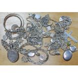 A mixed lot of silver and white metal jewellery including pendants, charm bracelets, chains etc.