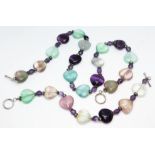 A fluorite necklace and matching bracelet, each formed from heart shape cut green, purple, pink