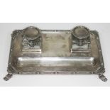 A presentation silver inkstand, with two square glass inkwells on base with Celtic border and four