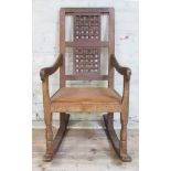 A Robert "Mouseman" Thompson of Kilburn oak rocking chair with lattice back, studded leather seat