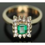 A diamond and emerald cluster ring, marked 18k, the cluster measuring approx. 9mm x 8mm, gross wt.