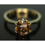 A diamond solitaire ring featuring a round brilliant cut cognac colour diamond approx. 1.79