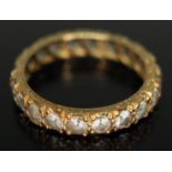 An 18ct gold and colourless synthetic spinel eternity ring marked 18ct, UK size L, gross weight 2.