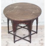 A Moorish oak occasional table in the manner of Liberty & Co, round top above hexagonal section base