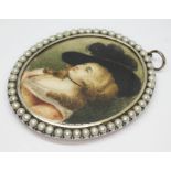An early 19th century portrait miniature on ivory, the white metal oval set with pearls, length 8cm.
