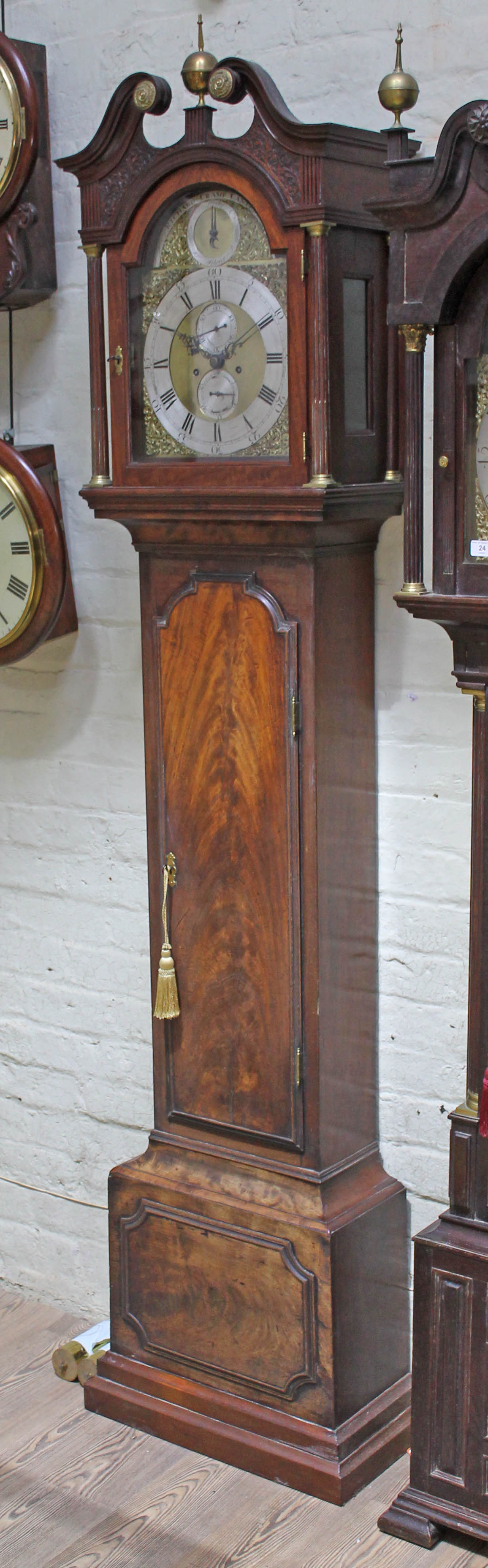 A George III 8 day mahogany long case clock, broken swan neck pediment with single brass finial,