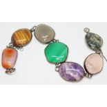A vintage mixed gemstone bracelet featuring irregular shaped cabochons of quartz varieties cat's