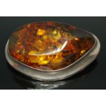 A Modernist amber brooch of abstract form, marked 925, length 46mm.