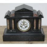 A Victorian black slate and marble mantel clock with visible brocot escapement, length 37cm.