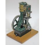 A Stuart Turner model 5A live steam vertical engine, on mounted on wooden board, height 38cm.