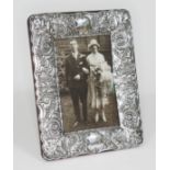 A late Victorian embossed silver photograph frame, 15cm x 19.5cm, Mappin & Webb, London 1900, red