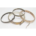 A group of three hallmarked silver bangles and another marked Sterling Silver, gross wt. 42.42g.