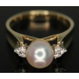 A cultured pearl and diamond ring, marked '14K' and '585', gross wt. 4.15g, size N/O.