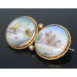 A 19th century yellow metal brooch with miniature landscapes on ivory depicting scenes from India,