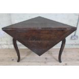 An early 18th century oak gate leg table of triangular form with single drop leaf forming a