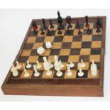 A 19th century bone chess set with fold out chess and backgammon board, kings 9cm in height,