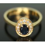 A diamond and sapphire cluster ring, the oval cluster measuring approx. 9mm x 8mm, band marked