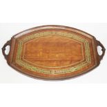 A late Victorian brass inlaid oak tray of oval form with carved handles, length 72cm.