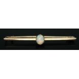 An early 20th century bar brooch set with a precious opal, marked 15ct, length 46mm, gross wt. 2.