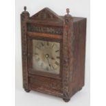 A German carved oak mantel clock by Winterhalder and Hofmeier, height 28cm.