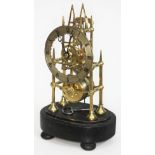 A Gothic arch style brass skeleton clock of small proportions, the chapter ring with Roman