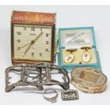 A mixed lot comprising an alarm clock, three white metal buckles, a pair of fire service