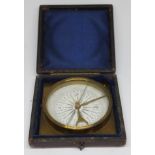 A brass compass, the 2 1/2" dial signed Casartelli Manchester, in leather case.