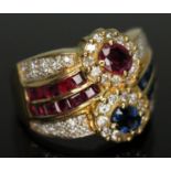 A diamond, ruby and sapphire cluster ring, marked '14k', gross wt. 7.70g, size M.