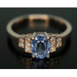 A sapphire and diamond ring featuring an oval cut sapphire weighing approx. 1.10ct, band marked '