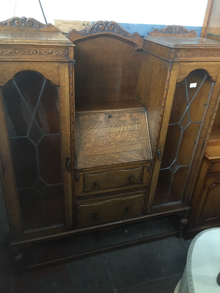 An oak 1930s/40s display cabinet with center bureau. Live bidding available via our website, if